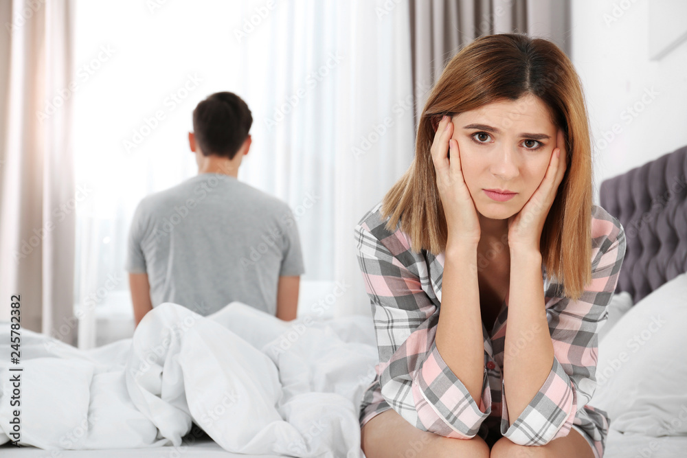 Couple with relationship problems ignoring each other in bedroom Couple with relationship problems ignoring each other in bedroom