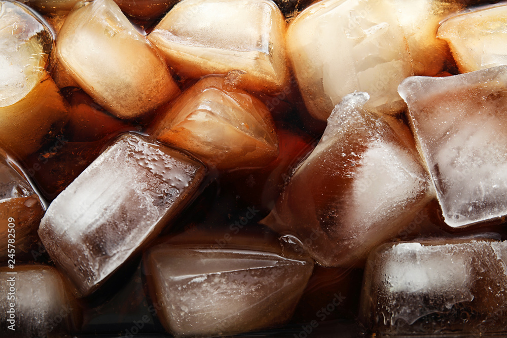 Closeup view of tasty refreshing cola with ice cubes as background Closeup view of tasty refreshing cola with ice cubes as background