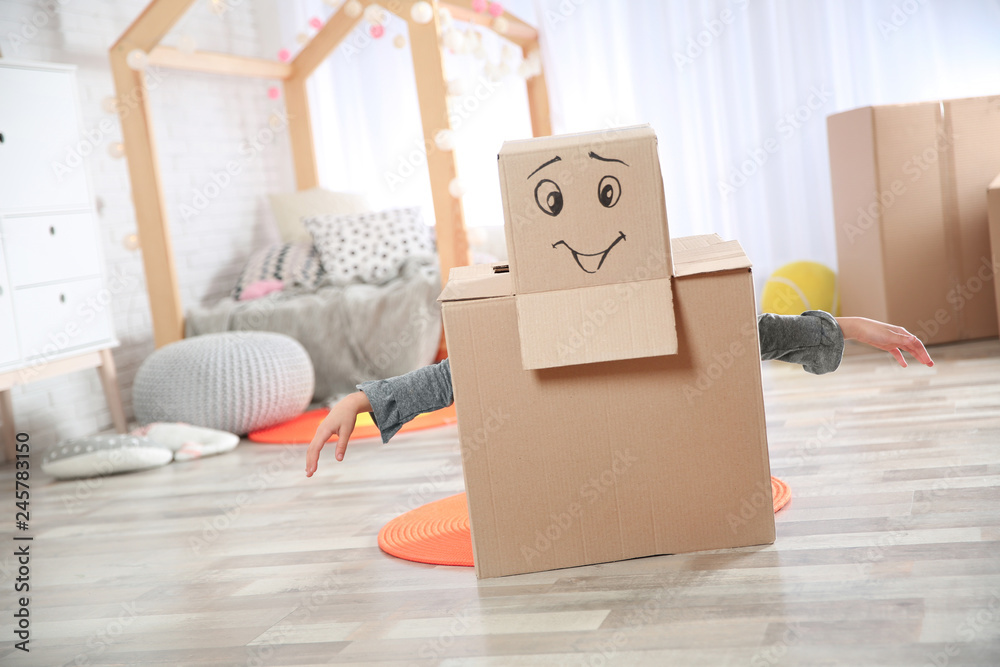 Fototapeta premium Cute little child wearing cardboard costume in bedroom