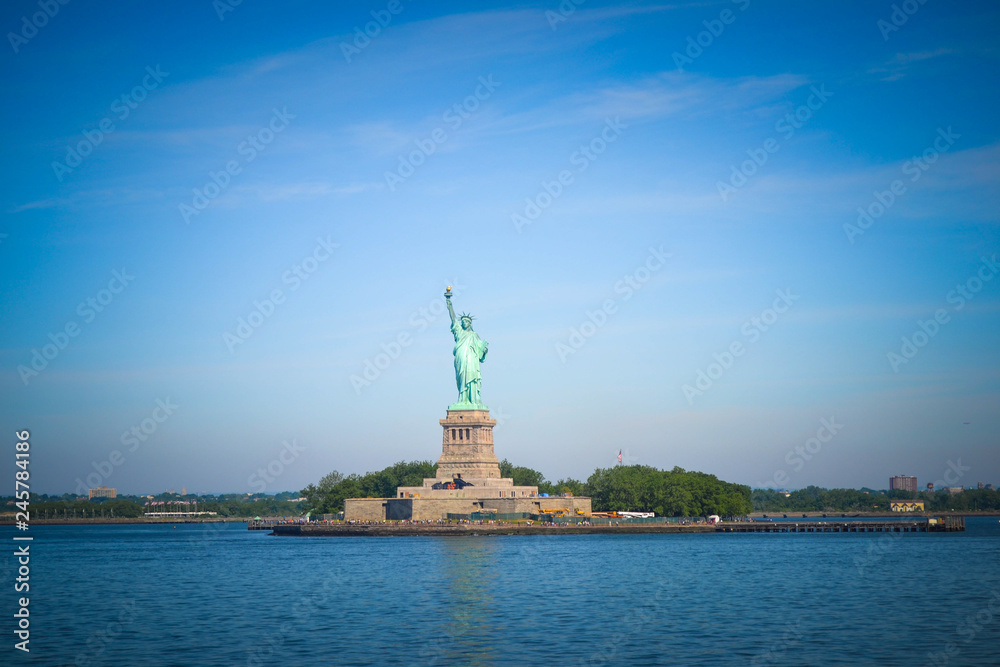 Wide angle view of the Statue of Liberty in New York City as seen from Hudson River Bay Wide angle view of the Statue of Liberty in New York City as seen from Hudson River Bay