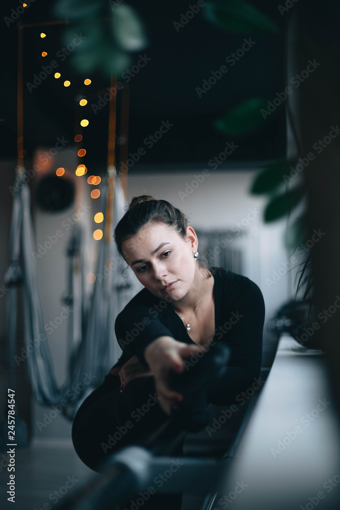 Young beautiful woman in the gym engaged in aerial yoga and stretching on hammocks. Young beautiful woman in the gym engaged in aerial yoga and stretching on hammocks.