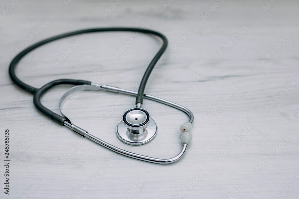 Medical stethoscope, phonendoscope on a wooden table. concept of medical care Medical stethoscope, phonendoscope on a wooden table. concept of medical care