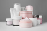 Different body care products on gray background
