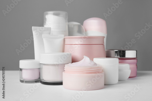 Different body care products on gray background