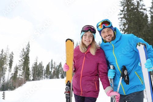 Couple of skiers on slope at resort. Winter vacation