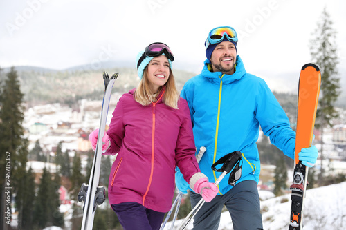 Couple of skiers on slope at resort. Winter vacation