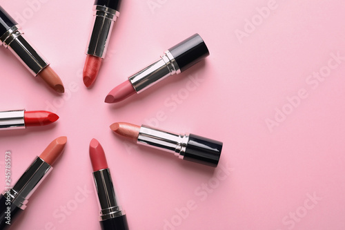 Flat lay composition with lipsticks and space for text on color background