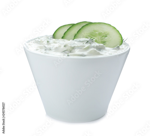 Bowl with cucumber sauce on white background