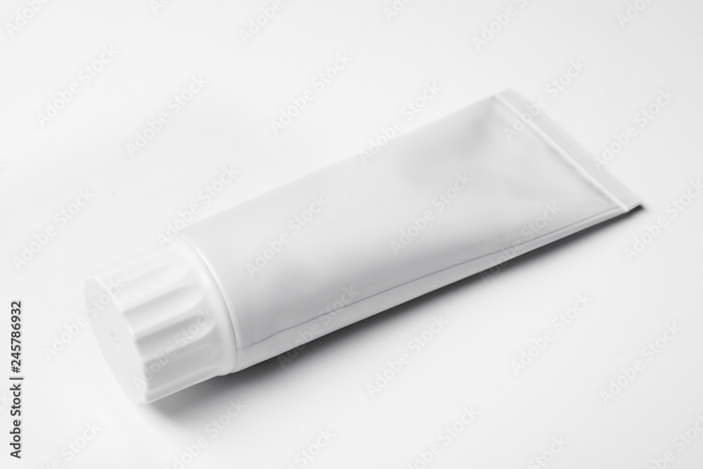 Blank tube of toothpaste on white background