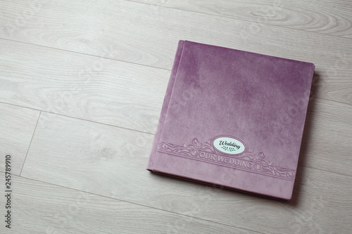 pink photo book with  fabric cover..
Photo book on a light background.

Photo album with a hard cover on a wooden background.
Bright  photo album.

