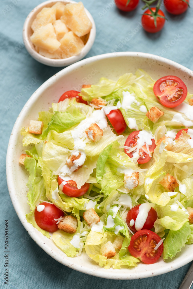 Caesar salad with sauce on plate, top view, closeup Caesar salad with sauce on plate, top view, closeup