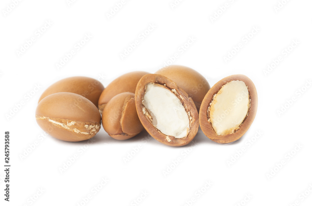 ARGAN SEEDS isolated on a white background. Argan oil and argan nuts concept ARGAN SEEDS isolated on a white background. Argan oil and argan nuts concept