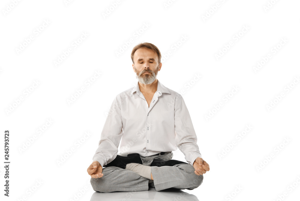 Senior bearded old man practicing yoga classic asana pose isolated on white Senior bearded old man practicing yoga classic asana pose isolated on white