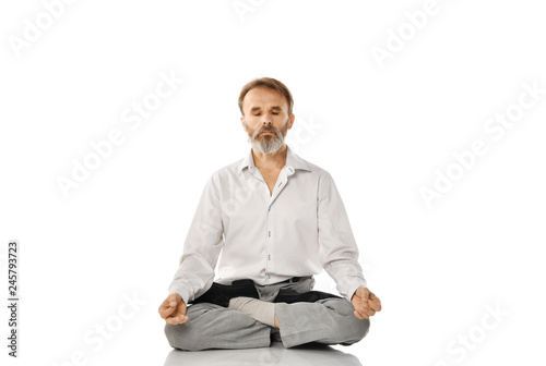 Senior bearded old man practicing yoga classic asana pose isolated on white 