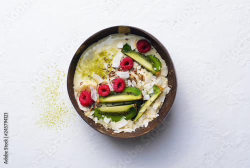 Smoothie Bowl Topped with Raspberry, Kiwi, Chia, Flaxseed and Coconut