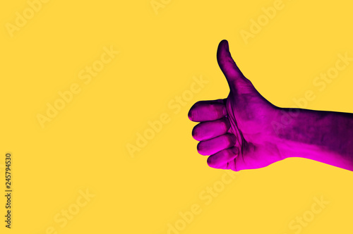 Isolated hand photo on yellow background. Pink hand collage style. Bright pop art template with space for text. Creative minimalistic backdrop. Poster, banner idea. Gestures with fingers photo