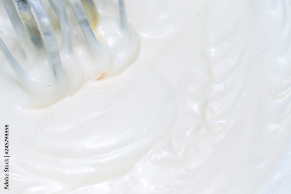 Mixing white egg cream in a bowl with a motor mixer, baking cake Mixing white egg cream in a bowl with a motor mixer, baking cake