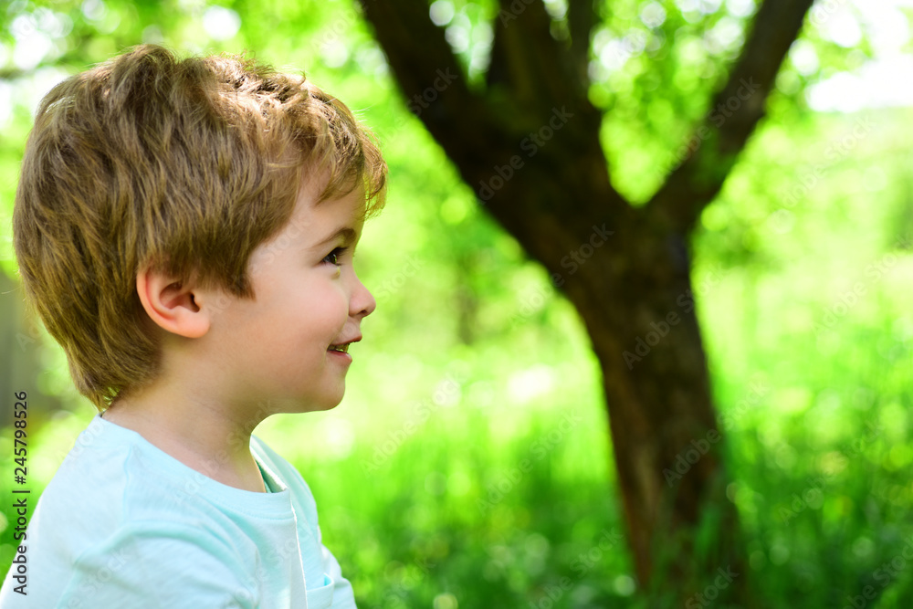 Child on green nature background. Spring and joy. Little boy looks away. Portrait. Allergy and pollinosis. Beautiful baby face. Child on green nature background. Spring and joy. Little boy looks away. Portrait. Allergy and pollinosis. Beautiful baby face.