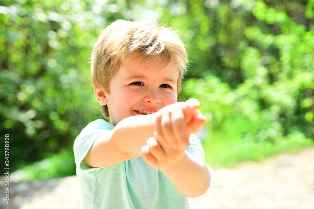 Cute child point at somewhere with the help of his finger. Happy child outside. Scincere cheerful emotions from kid. Summer walk on fresh air in forest. Active holidays with children Cute child point at somewhere with the help of his finger. Happy child outside. Scincere cheerful emotions from kid. Summer walk on fresh air in forest. Active holidays with children