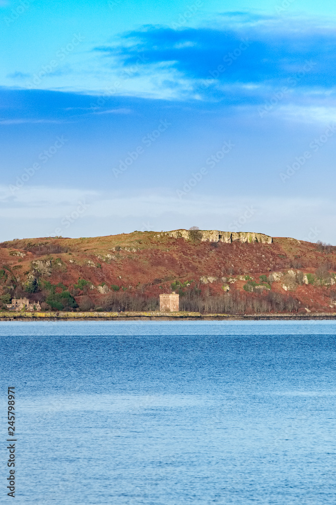 Little Cumbrae from Portencross North Ayrshire on a Cold Day in Scotland and the Ancient Ruins of the Old Castle. Little Cumbrae from Portencross North Ayrshire on a Cold Day in Scotland and the Ancient Ruins of the Old Castle.