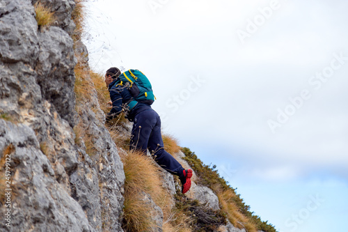 Man with backpack climbing
