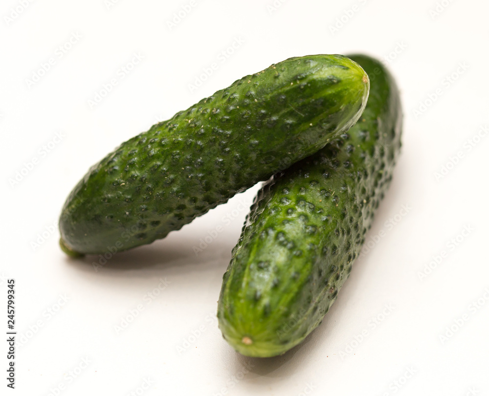two cucumbers on a white background two cucumbers on a white background