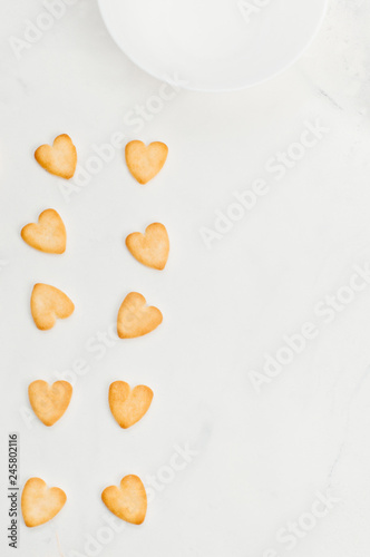 Heart shape cookies on light marble background with copy space