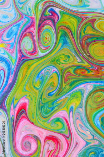 Fluid art from different colors. Multicolored background from paints on liquid. Bright pattern on liquid. Colored paint stains in style of pop art