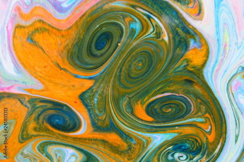 Fluid art from different colors. Multicolored background from paints on liquid. Bright pattern on liquid. Colored paint stains in style of pop art