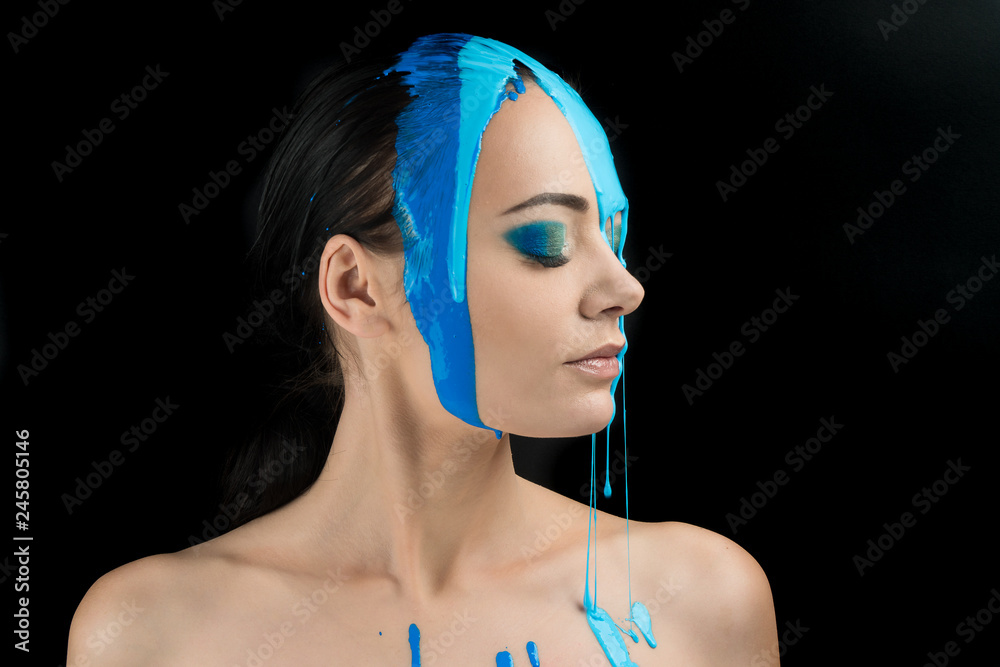 Fotka „Fashion Model Girl colorful face paint. Beauty fashion art portrait  of beautiful woman with flowing liquid paint, abstract makeup. Vivid paint  make-up, bright colors. Vogue Multicolor creative make-up“ ze služby Stock