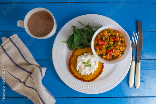 Traditional colombian breakfast huevos pericos with corn cakes photo