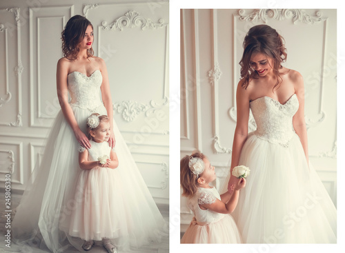 Cute fashionable portrait of mother and daughter in wedding dresses. Childhood, fashion, happiness concept