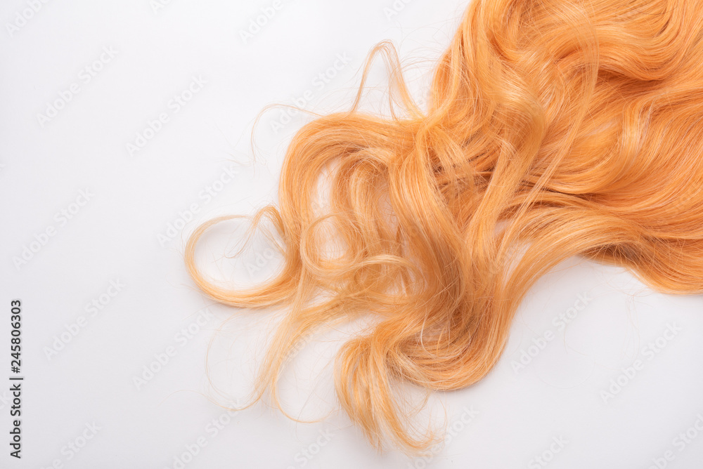 Human, natural honey-colored blond hair on white isolated background. Stylish, fashionable colors this year. Honey blonde shaken, wave and undulating hair. An example of hairstyle. Human, natural honey-colored blond hair on white isolated background. Stylish, fashionable colors this year. Honey blonde shaken, wave and undulating hair. An example of hairstyle.