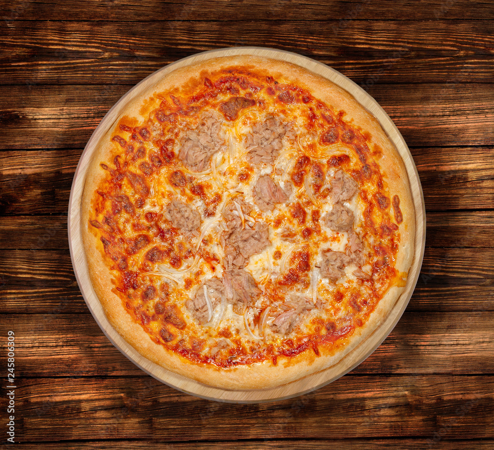 Isolated Tuna Pizza on a wooden background. Isolated Tuna Pizza on a wooden background.