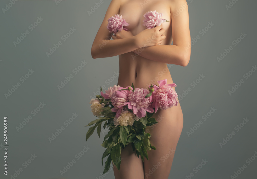 Woman. Breast and vagina concept. Women's health and beauty. Spa and  medicine. Pink peonies on a naked female body. Underwear for women. Fashion  and nature. Ecological concept. Beauty of young woman Stock