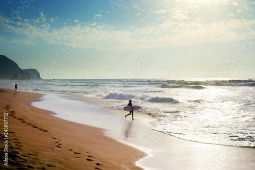Surfer running to surf