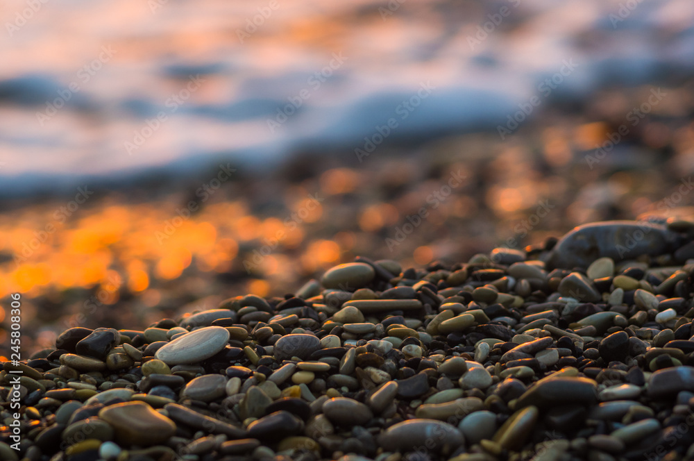 pebble stones on the sea beach, the rolling waves of the sea with foam pebble stones on the sea beach, the rolling waves of the sea with foam
