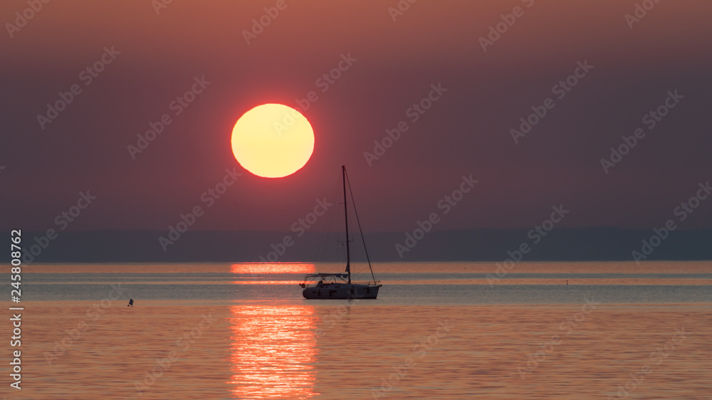 Sunset with sailing boat in Cres Croatia