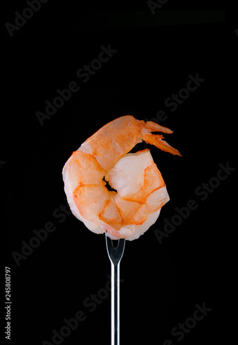 Mix of shrimp, lemon, cheese. Delicious seafood appetizer on a black background.