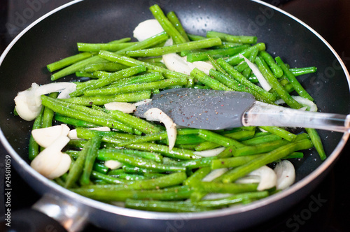 Fotografie Green beans with onion and garlic ready for cooking in frying pan