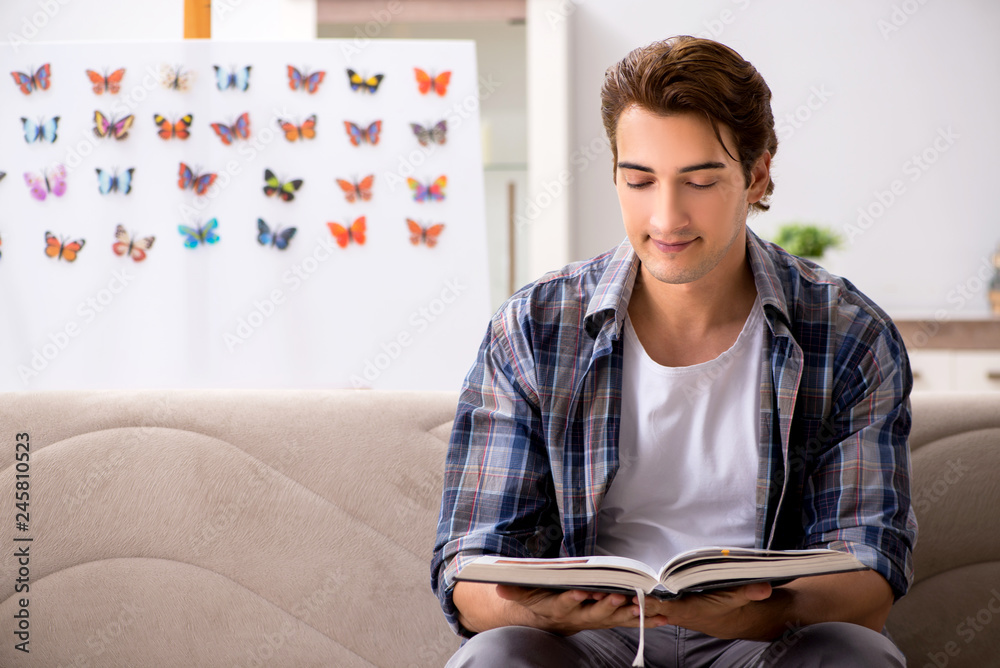 Student entomologist studying new species of butterflies Student entomologist studying new species of butterflies