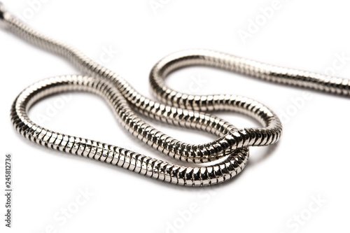 Silver chain on white background. Focus on foreground.