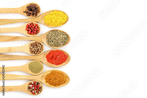 mix of spices on w isolated on wooden spoon a white background with copy space for your text. Top view. Flat lay. Set or collection