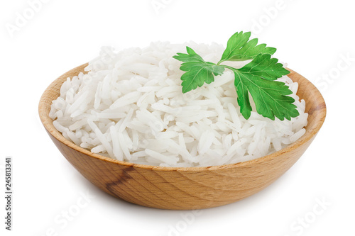 rice in a wooden bowl isolated on white background. Top view. Flat lay photo