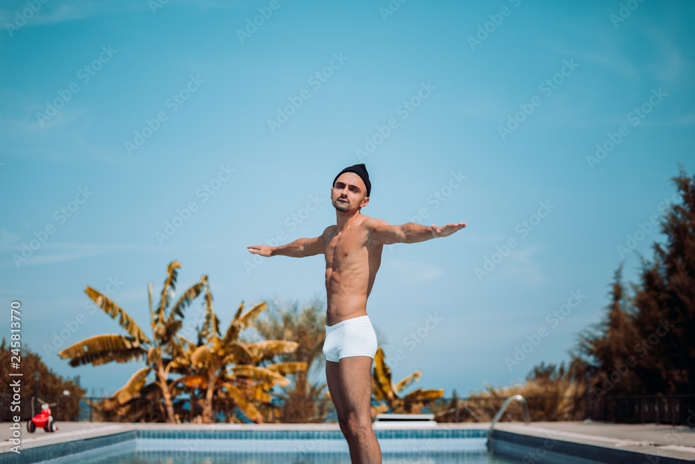 Cheerful guy on vacation by the pool