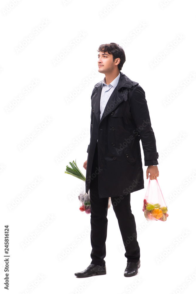 Young handsome man with vegatables in shopping concept Young handsome man with vegatables in shopping concept