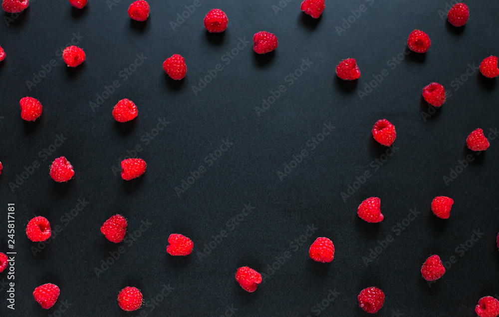 Round Frame of red raspberry berries on black background