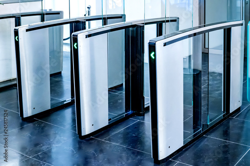 Turnstiles. Checkpoint. Automatic access control. Access system in the building. Automatic turnstile with sliding doors to control the flow of people. Entrance hall with turnstile photo