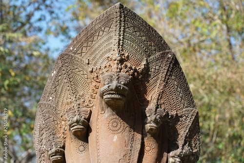 Siem Reap,Cambodia-January 13, 2019: The intricate Naga balustrades, carved out from a one-pieced, continuous in-length sand stone, at south causeway of Beng Mealea in Siem Reap, Cambodia
 photo