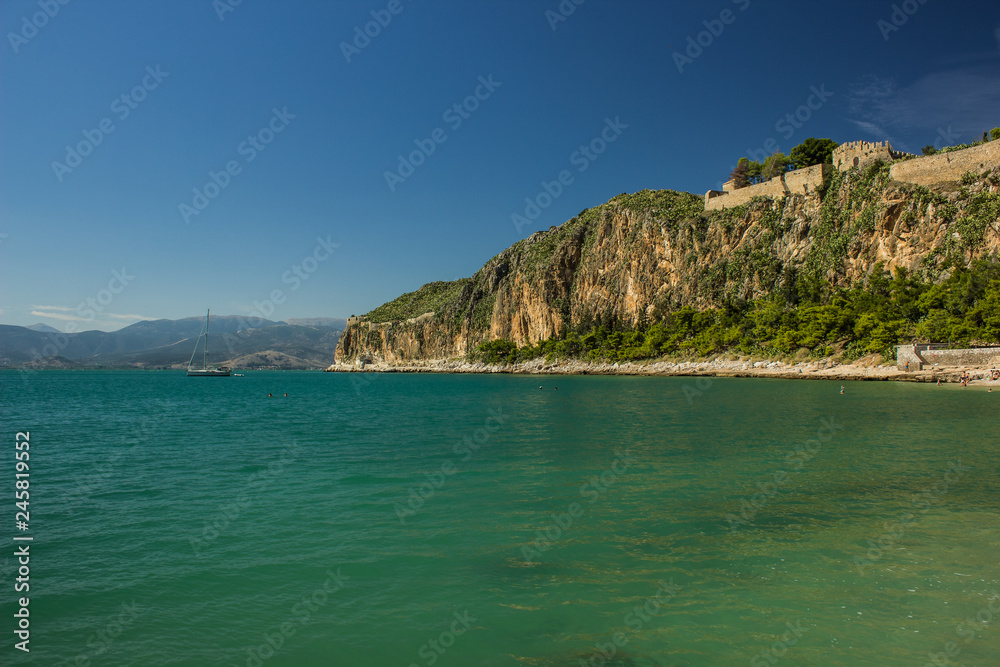 vivid colorful sea shoreline and mountain steep rock cape with castle on a top